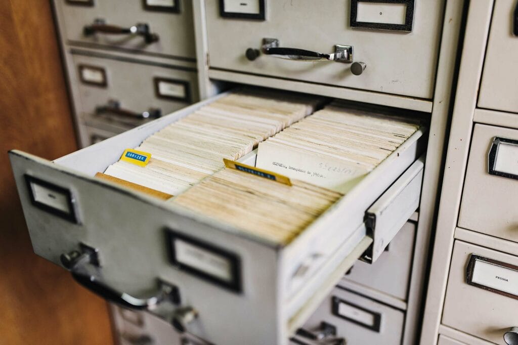 An open filing cabinet drawer of labeled document folders