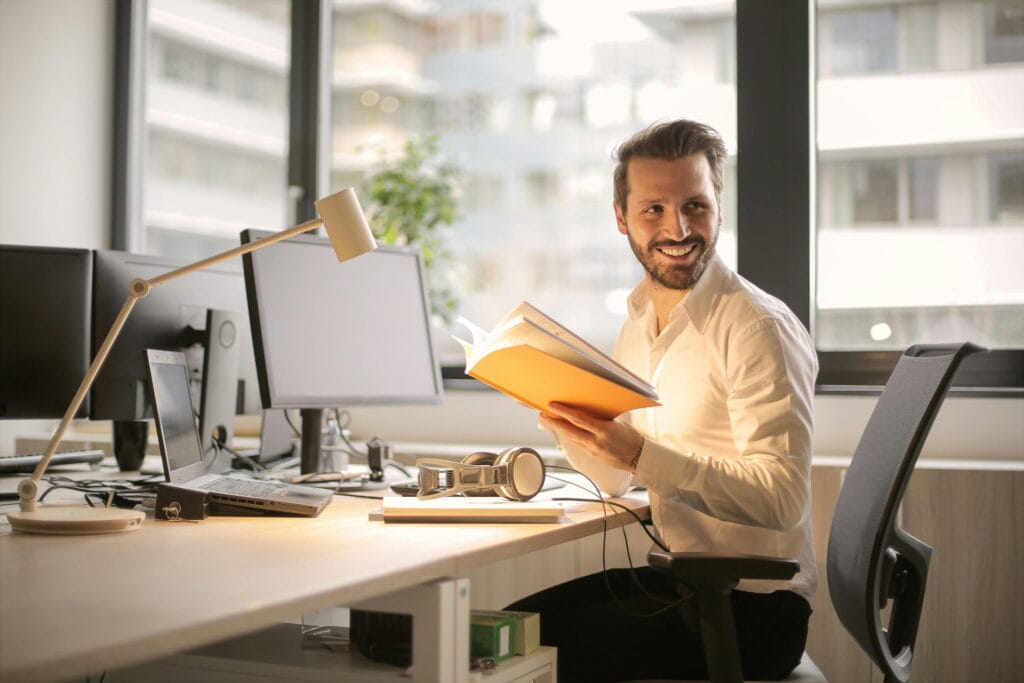 A professional reviewing documents in a bright office