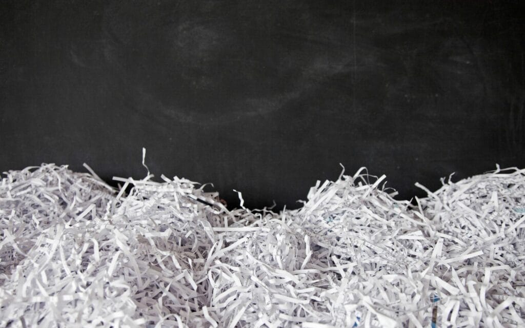 Encouraging co-workers to shred their documents leads to a large pile of shredded paper.