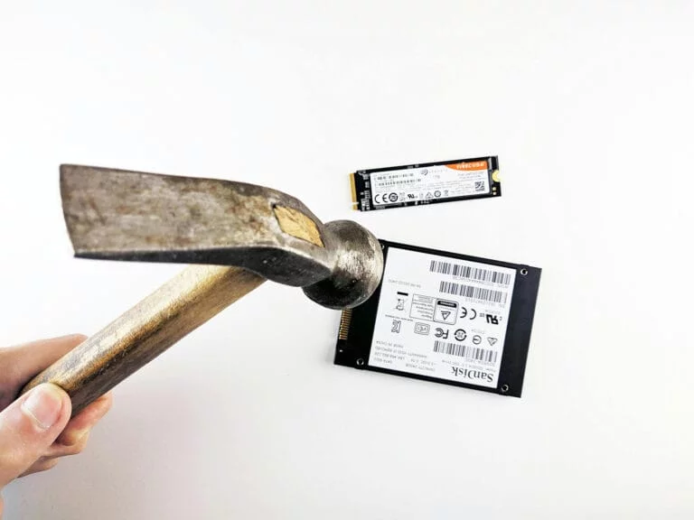 Hammer above two SSD drives, white background.