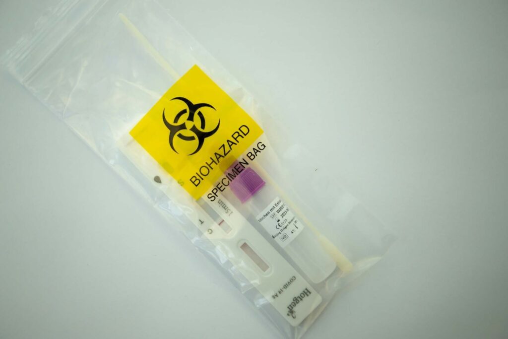 Biohazard specimen bag with test kit inside.