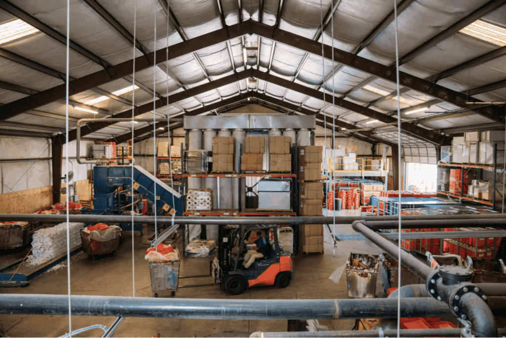 Industrial warehouse with forklift and stacked boxes.