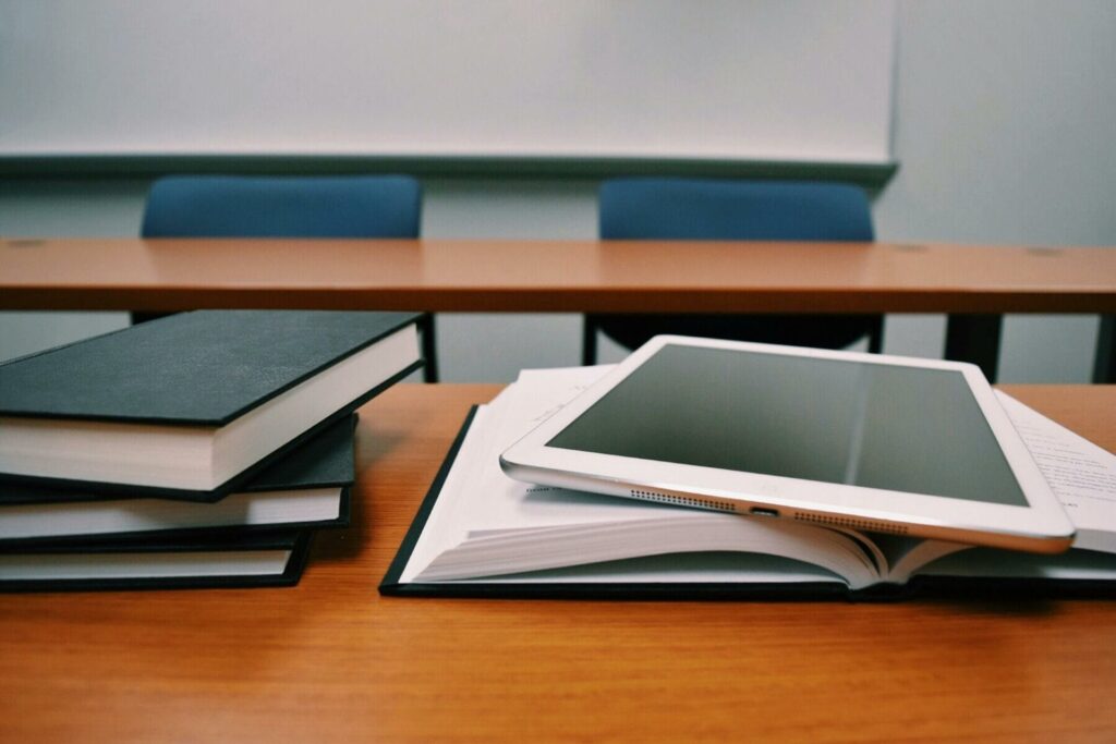 Classroom desk with books and tablet