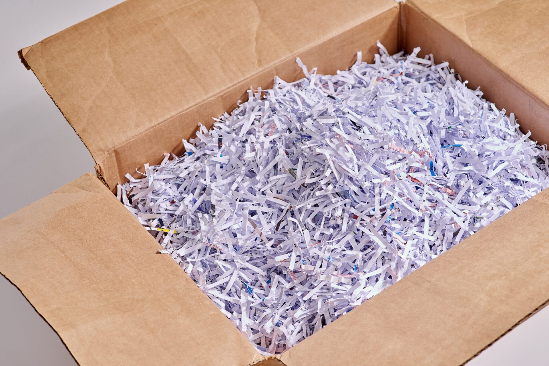 shredded paper in a cardboard box