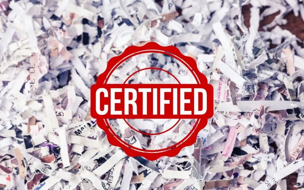 Certified stamp over shredded documents background