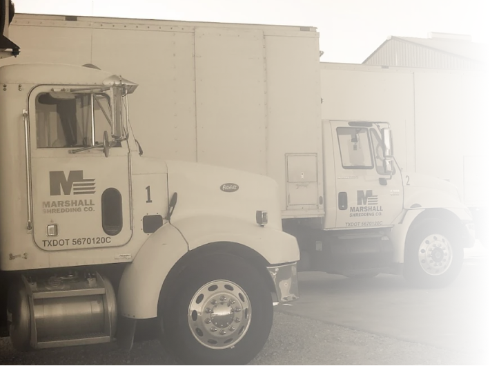 Two white Marshall Shredding trucks parked side by side